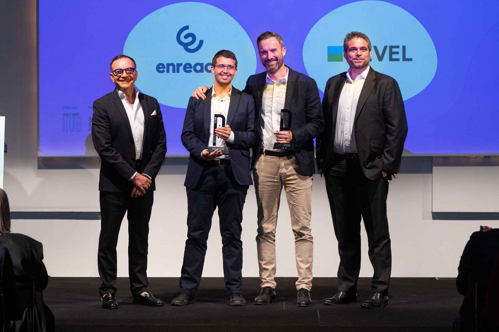 Award ceremony photo with representatives from Enreach, LEVEL, and Atento
